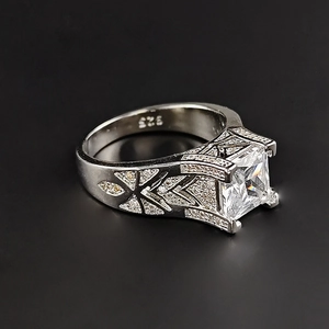 Close-up of S925 sterling silver ring featuring a princess cut cubic zirconia and pavé band