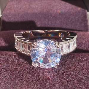 Luxurious silver ring with AAA cubic zirconia in four-prong setting and baguette side stones