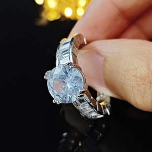 Luxury AAA zircon ring with round center stone and baguette side diamonds on silver band