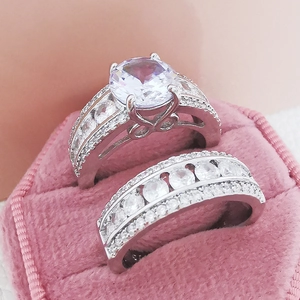 Luxury silver-tone couple ring set with sparkling zircon stones in a pink velvet jewelry box