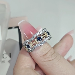 Elegant women's silver ring set with three oval blue sapphires and sparkling crystals