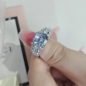 Classic silver ring with a large round blue zircon and micro-pave side stones