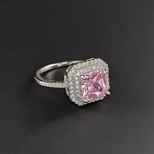Macro shot of luxury ring with pink square zircon centerpiece and diamond pavé details
