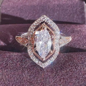 Elegant marquise-cut gemstone ring in rose gold and silver finish on purple velvet