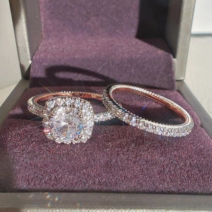 Luxury rose gold bridal set with halo diamond ring and pavé band in a velvet box