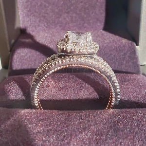 Elegant halo engagement ring with a square-cut diamond in a purple velvet jewelry gift box