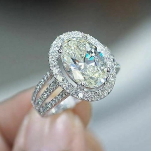 Classic oval-cut zircon halo engagement ring with triple row pavé bands in silver finish