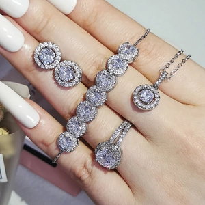 Silver-tone jewelry set with halo-set round white zircon stones for a trendy look