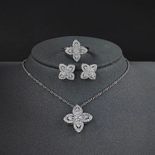 Exquisite four-piece silver jewelry set featuring floral necklace, earrings and ring