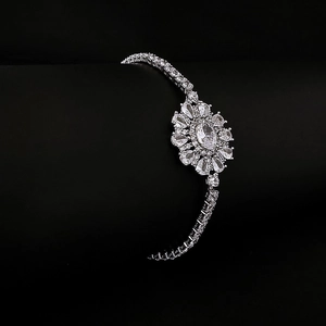 Elegant silver sunflower bracelet with sparkling teardrop zircons on a dark background