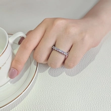 Detailed shot of an elegant eternity ring with light purple and blue rectangular crystals
