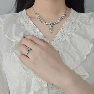 Luxury silver necklace and ring jewelry set with sparkling crystals on a model