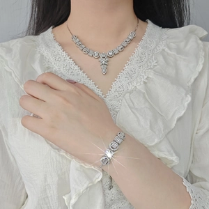 Elegant silver-toned jewelry set with sparkling rhinestones and adjustable bracelet