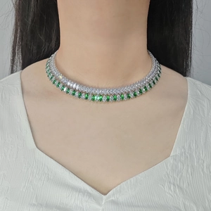 Macro view of double-layer emerald marquise-cut crystal necklace on a model's neck