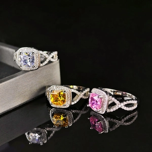 Three cushion-cut halo rings with infinity bands in white, yellow, and pink colors