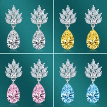Detail of pear-shaped gemstone earrings in four colors with sparkling leaf-shaped pavé accents