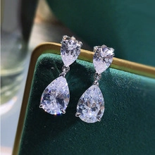 Detailed view of teardrop cubic zirconia earrings on green velvet jewelry box
