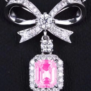 Sparkling pink gemstone butterfly pendant necklace with zircon bow detail on a silver chain