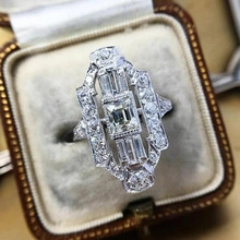 Detailed macro of vintage Art Deco ring with emerald-cut zircon in a luxury jewelry box