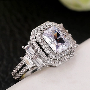 Luxurious silver ring featuring a large rectangular cubic zirconia with halo and side baguettes