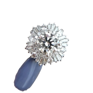 Luxurious snowflake ring with large round diamond and baguette cut halo on white background