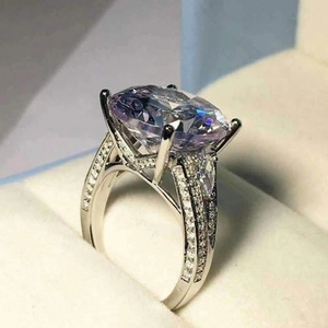 Elegant four-prong engagement ring with oval lavender stone and micro-pave diamonds