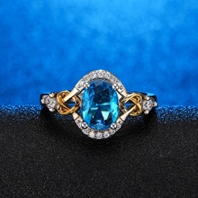 Macro detail of elegant vintage ring with oval blue gemstone and silver celtic knot design