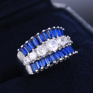 Luxurious silver wedding ring with round white zircons and blue sapphire-style gems