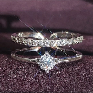 Elegant double-layered silver ring with round moissanite and pave stones on velvet