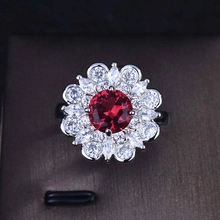 Macro shot of a sunflower ring with a red gemstone and white zirconia in a jewelry box