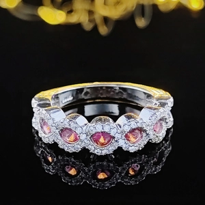 Luxurious silver ring with five round pink gemstones surrounded by tiny white crystals