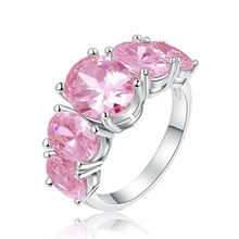 Detailed view of an open cuff ring with four oval-cut pink stones in a silver setting