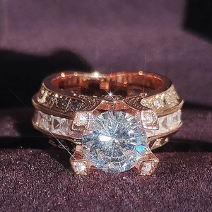 Luxurious rose gold ring featuring a large brilliant center stone and pavé setting