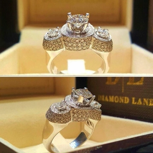 Luxurious silver ring with three main stones and pavé set diamonds in a jewelry box