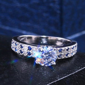 Elegant fashion ring featuring a central clear stone and blue zircon side stones in silver