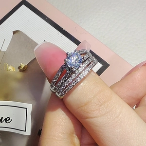 Detailed close-up of a three-piece bridal set ring with zircon inlay and silver plating