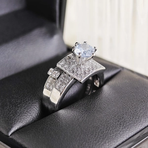 Macro detail of silver wedding ring set with brilliant round-cut diamond in six-prong setting
