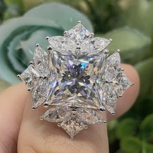 Close-up of elegant silver ring with peacock blue zircon and star-shaped crystal setting