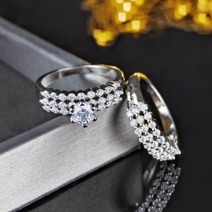 Macro shot of silver wedding ring set with large round centerpiece and double pave bands