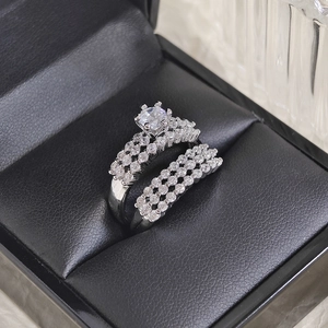 Macro view of silver engagement ring set with six-prong center stone in black gift box