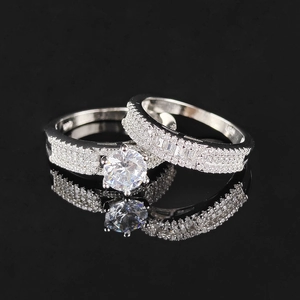 Macro view of double silver ring set featuring a large round main stone with mirror reflection