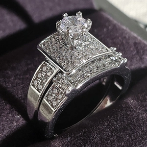 Elegant silver engagement wedding ring set with round cut cubic zirconia in a jewelry box