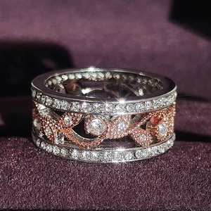 Elegant two-tone wide ring with cubic zirconia and hollow floral design on velvet