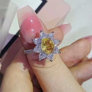 Macro shot of a sunflower ring with yellow gem center and white pear-cut zircon petals