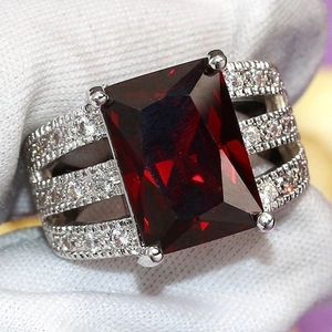 Luxury silver-tone ring with large rectangular ruby and triple-row zircon accents