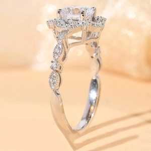 Sparkling silver halo ring with a large round moissanite center stone and pavé band