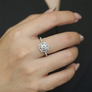 Elegant pear-shaped moissanite ring with halo cluster design worn on finger