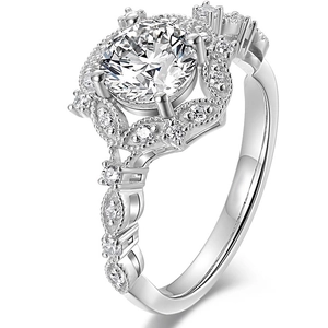 Elegant silver pear-shaped sparkling moissanite ring with a halo and vintage carvings