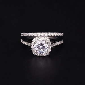 Conjunto de anillos de plata con circón brillante y piedra central redonda en fondo negro