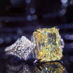 Luxurious 10x14mm radiant cut yellow zircon ring with side stones on a silver band